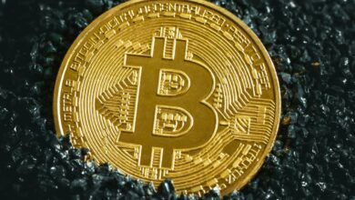 a bitcoin sitting on top of a black surface